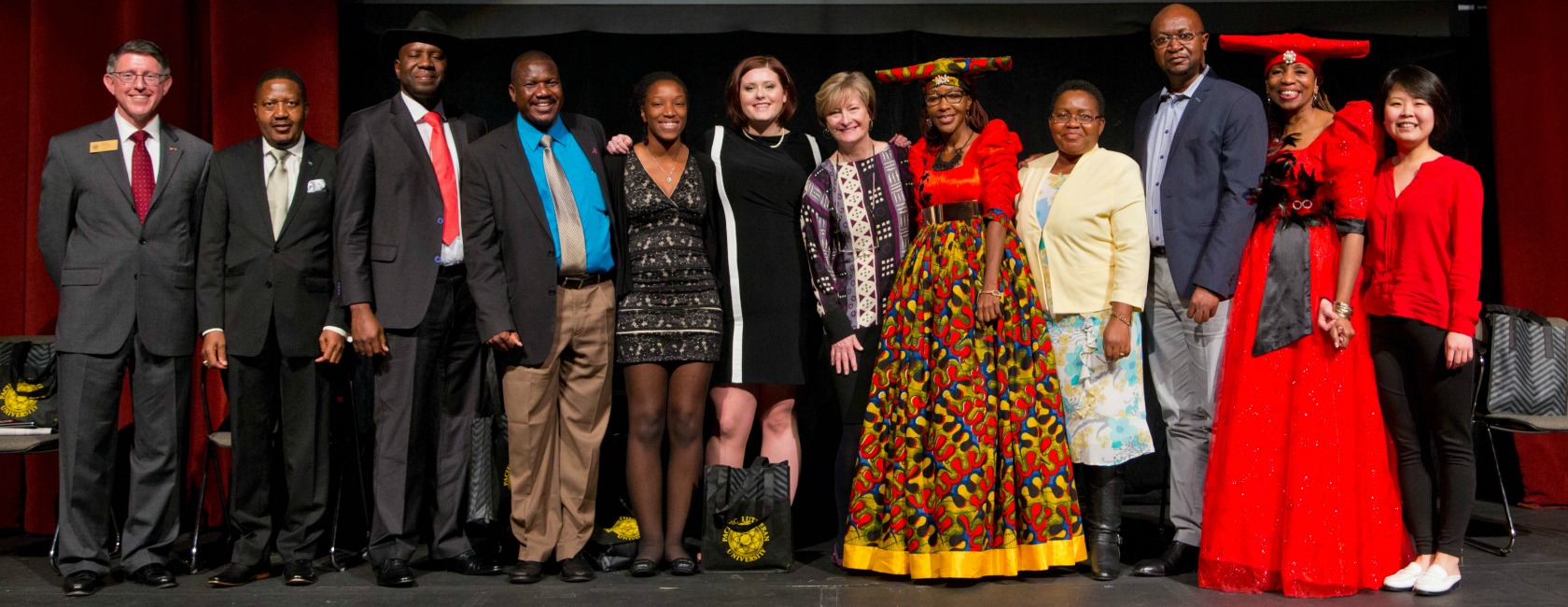 e, left, joins the "Namibia Nine" film team and Namibian PLU graduates at the documentary's premiere Feb. 28. (Photo: John Froschauer)