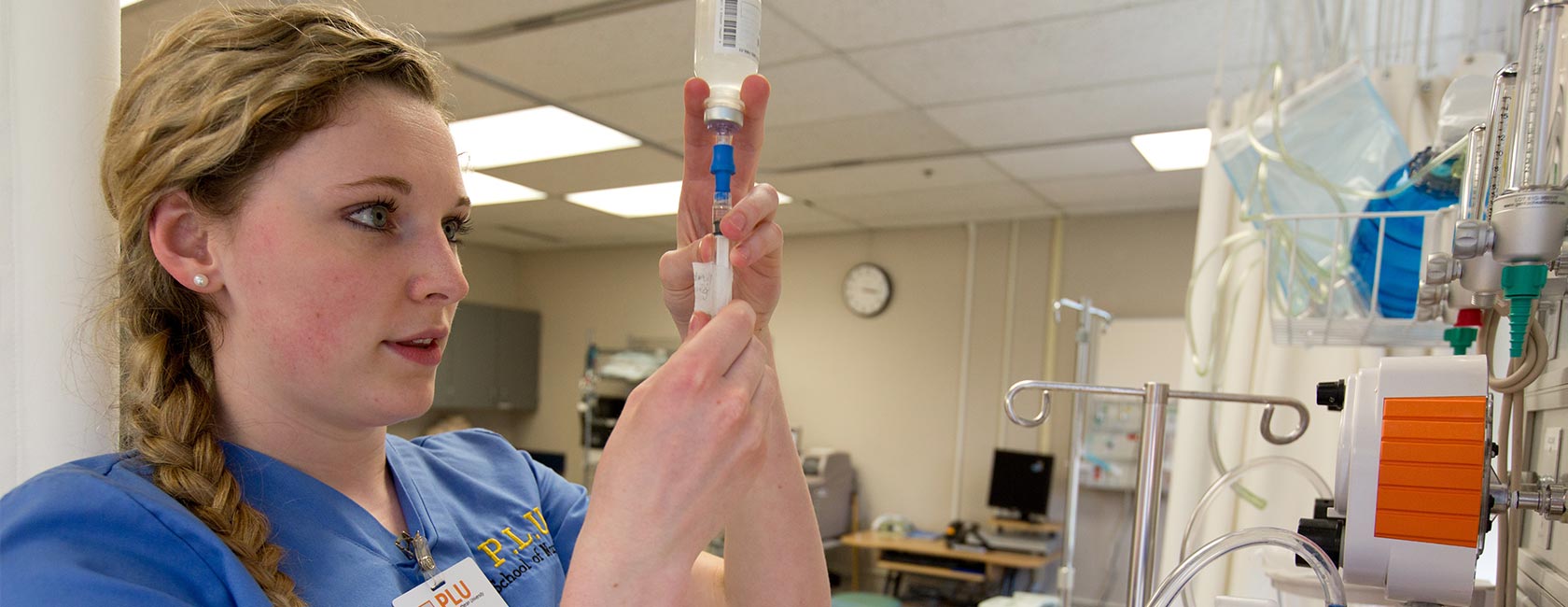 Nursing student working with an IV