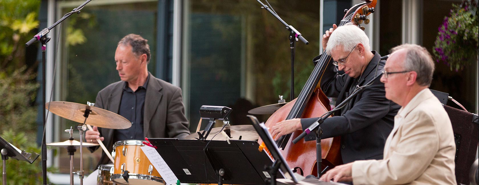 The Jazz Sound Trio, comprised of PLU faculty members David Deacon-Joyner on piano, Clipper Anderson on bass and Mark Ivester on drums, performs at Jazz Under the Stars at the Gonyea House. (photo: John Froschauer/PLU)