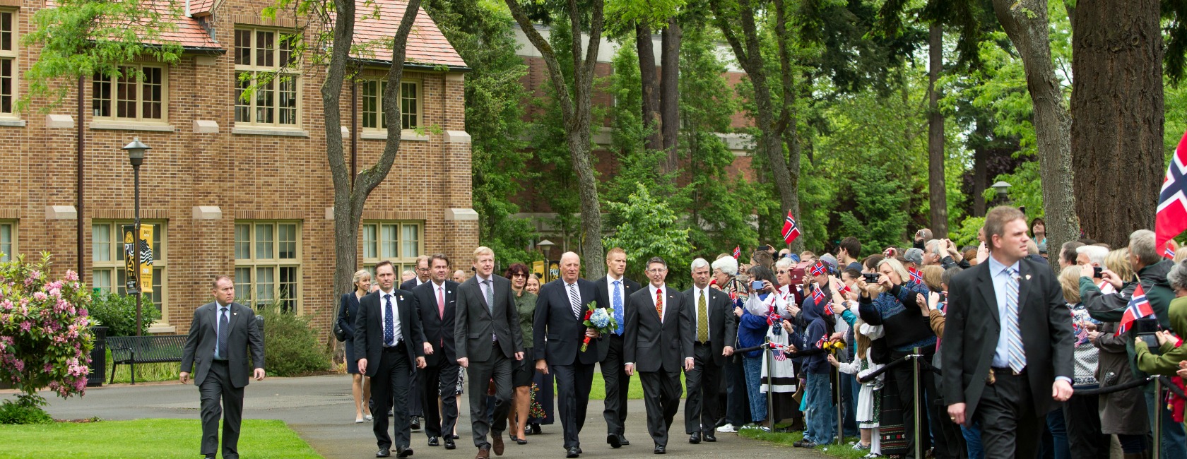 HM King Harald V of Norway walks with President Thomas Krise during his visit to Pacific Lutheran University on Saturday, May 23, 2015. Later His Majesty delivered the commencement address and received an honorary degree. (Photo: John Froschauer/PLU)