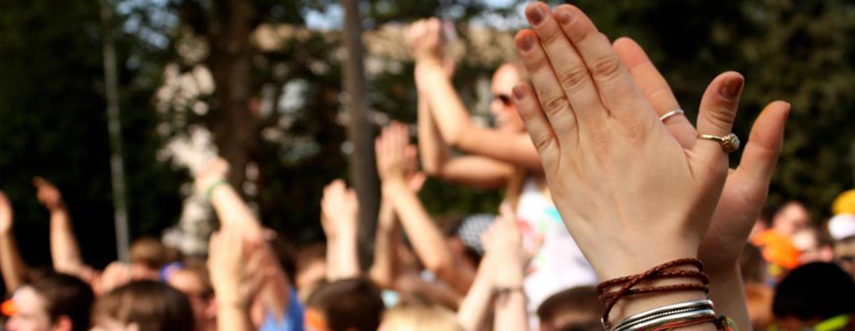 LollaPLUza concert, up close photo of hands clapping
