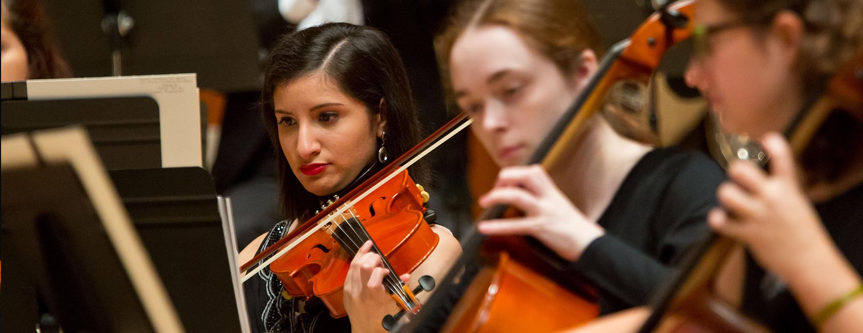 Students playing violins and cellos