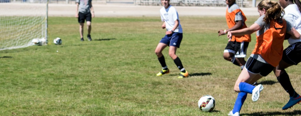 Young people play soccer at Colleen Hacker's Success Soccer Camp.