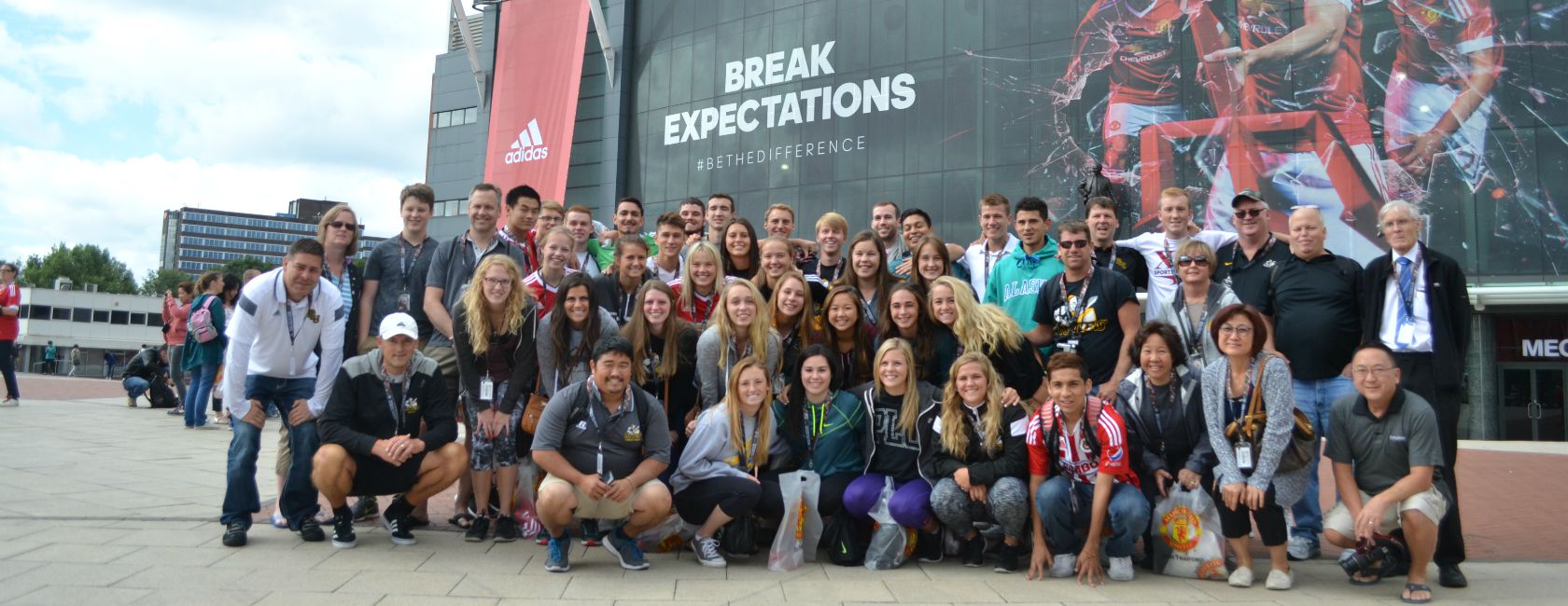 The PLU soccer community poses in front of the Manchester United stadium during a 10-day trip to England. (Photo courtesy assistant athletic trainer Todd Yamauchi.)