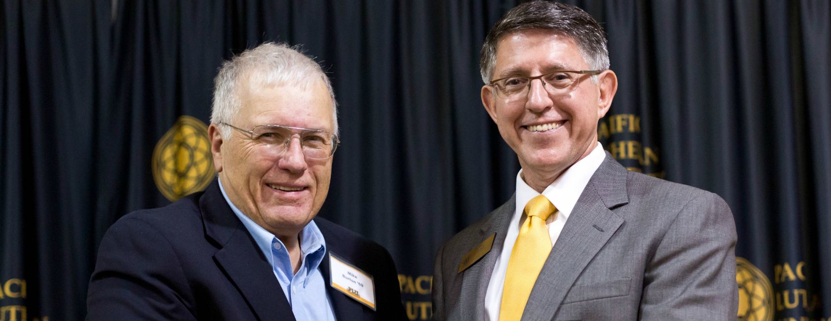 PLU President Thomas W. Krise, right, presents Mike Burton '69 with the 2014 Distinguished Alumnus Award. (Photo: John Froschauer/PLU)