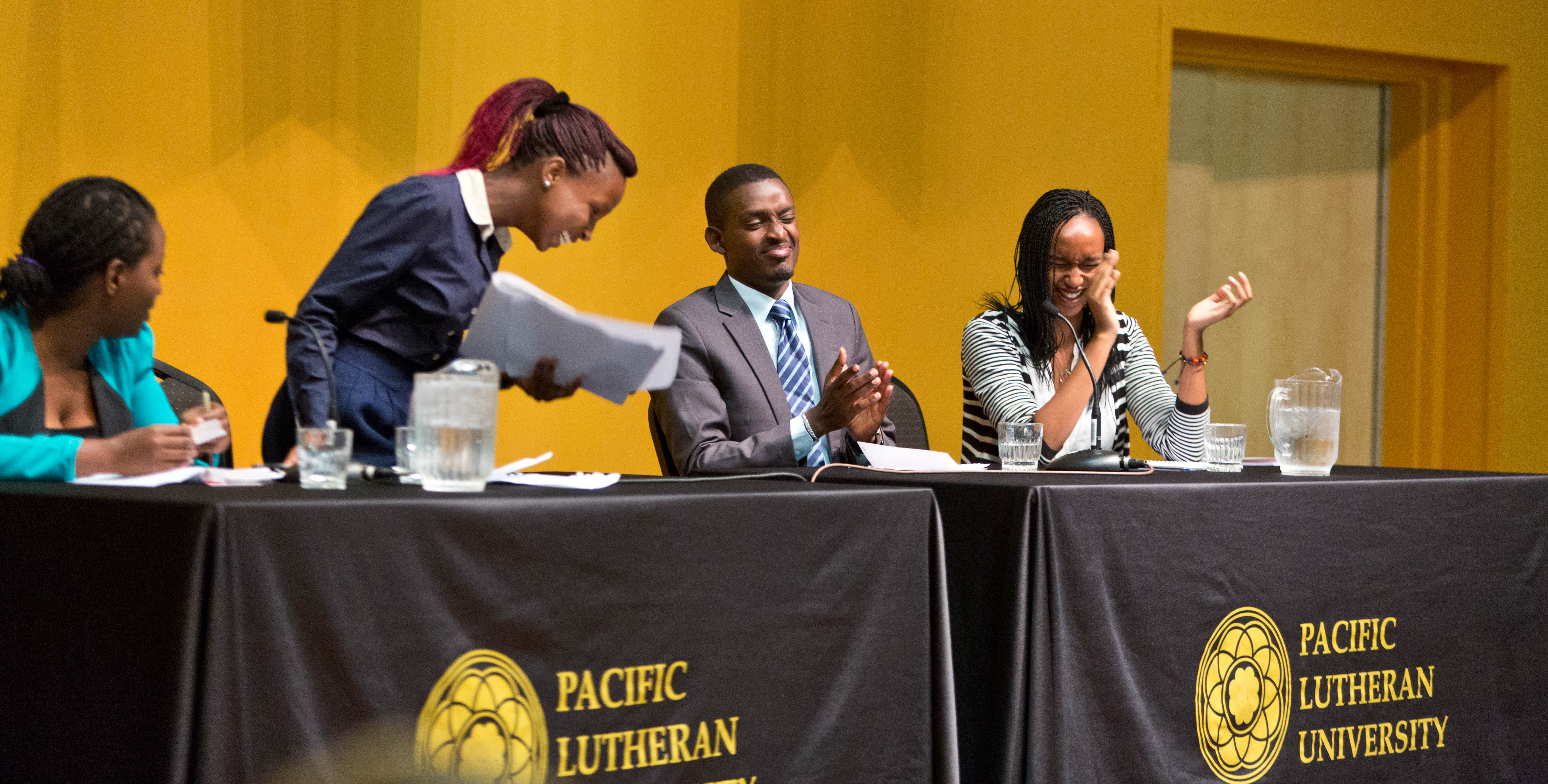 iDebate Rwanda members share a laugh during a presentation at PLU. (Photo: John Froschauer/PLU)