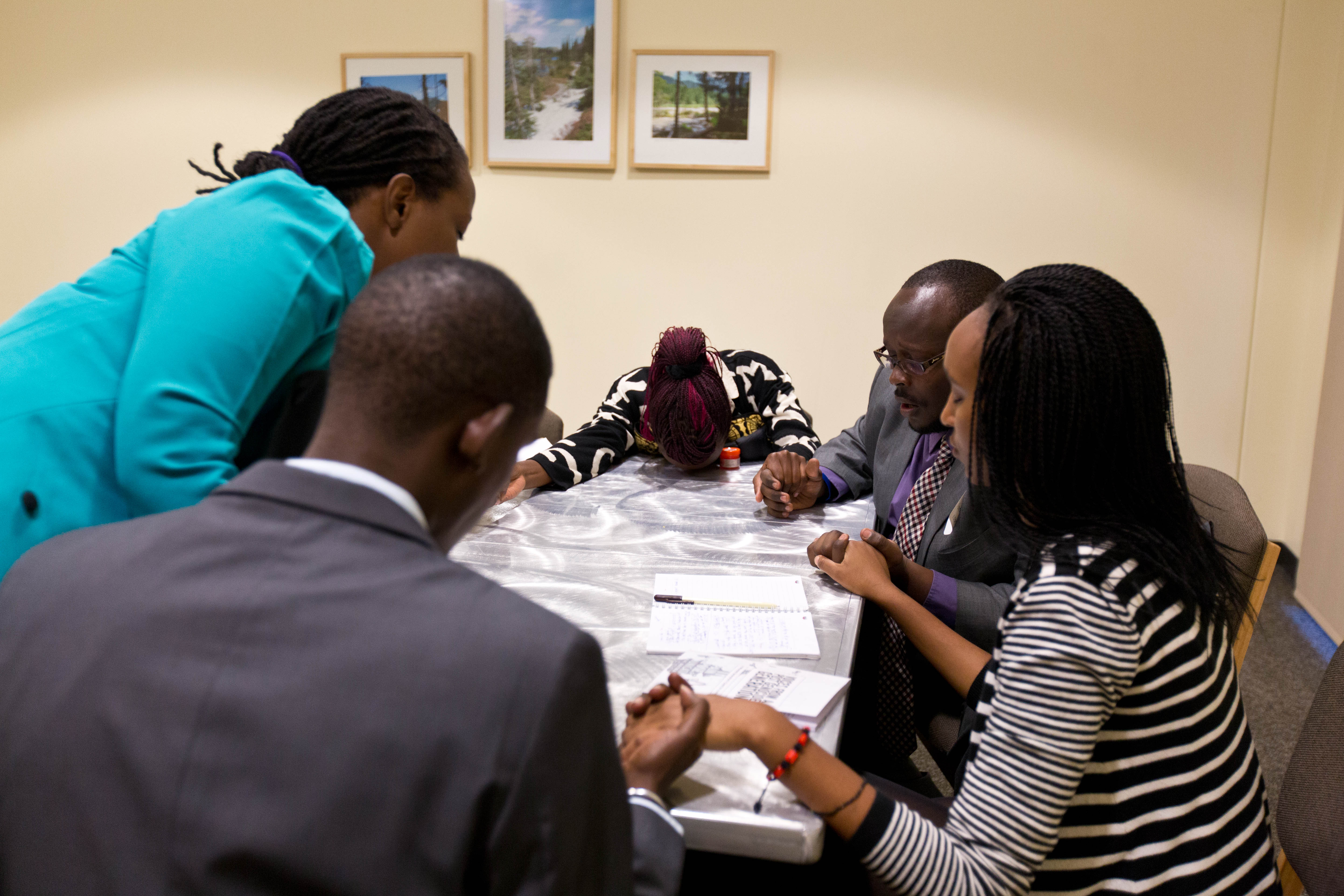 Team members pray before the debate in Anderson University Center. (Photo: John Froschauer/PLU)