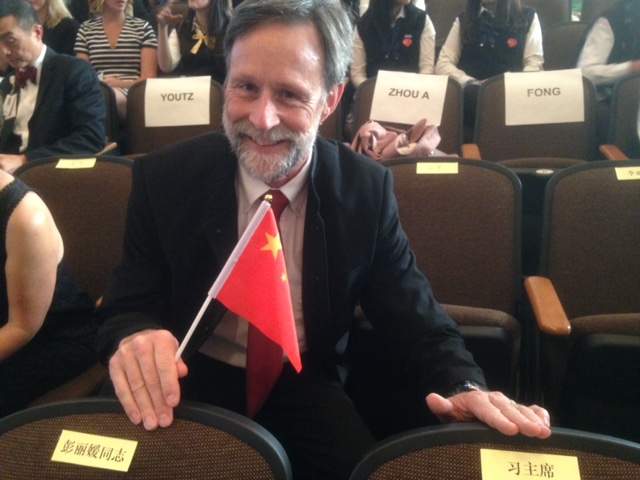 Dr. Gregory Youtz sits behind seats designated for the Chinese president and his wife at Tacoma’s Lincoln High School. (Photo: Courtesy Dr. Gregory Youtz)