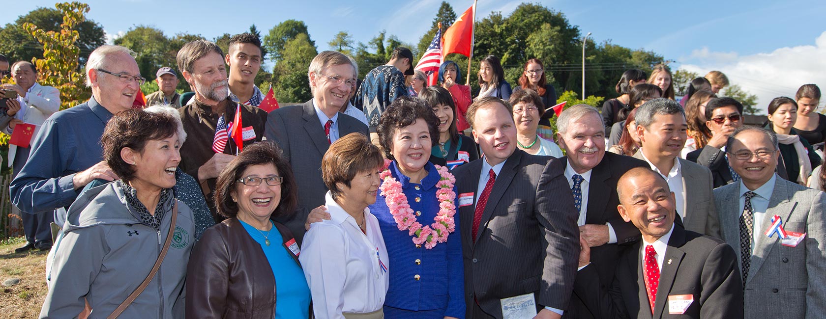PLU Professor of Music Greg Youtz (back row, second from left) joins elected officials and community leaders in welcoming the Honorable Qiu Yuan Ping, Minister of Overseas Chinese Commission (front row, fourth from left), to Tacoma's Chinese Reconciliation Park. (Photo by John Froschauer/PLU)