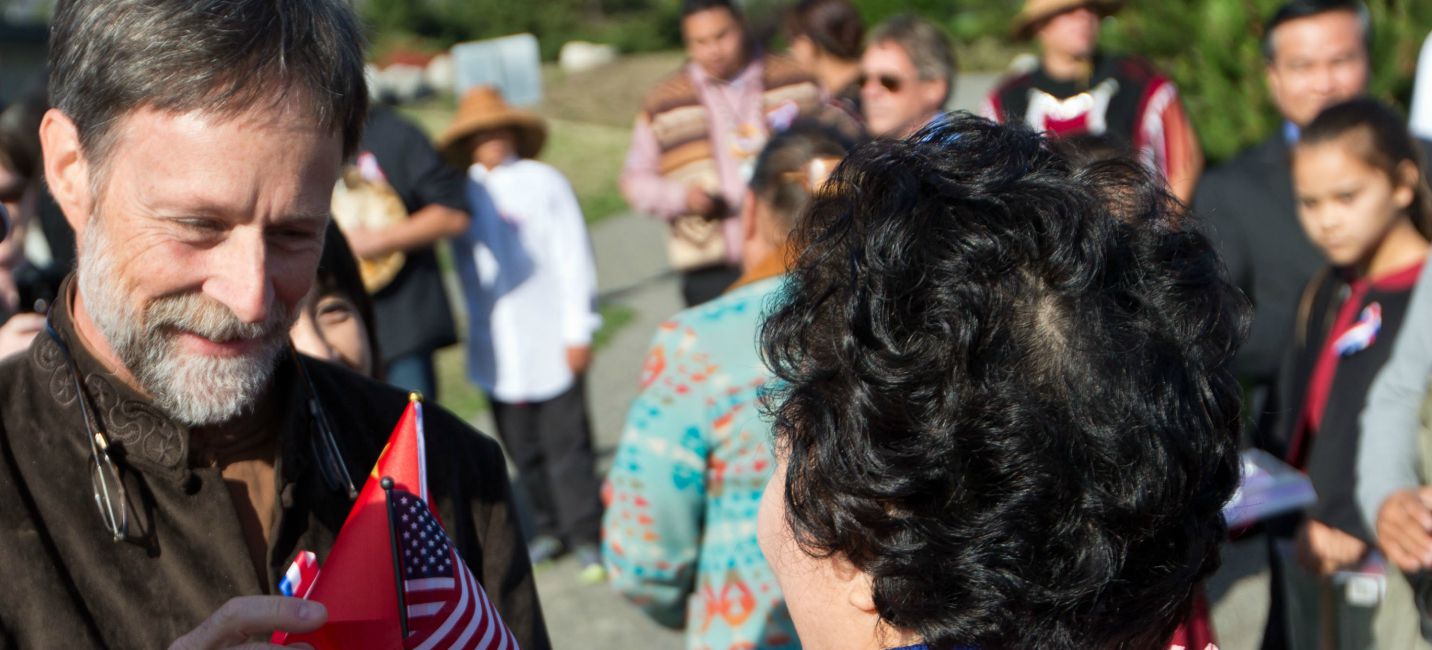 PLU Professor of Music Gregory Youtz, left, greets Qiu Yuan Ping, Minister of Overseas Chinese Commission, China State Department, at the Chinese Reconciliation Park in Tacoma on Sept. 21. (Photo: John Froschauer/PLU)