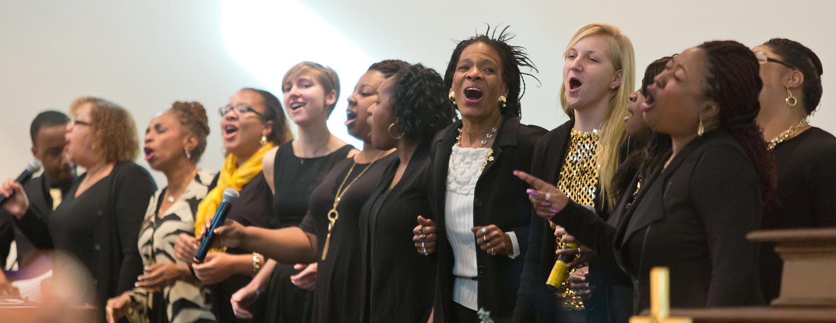 Business major Thomas Copeland '17 (far left), PLU Director of Multicultural Recruitment Melannie Denise Cunningham (third from left), physics major Sydney Spray '19 (fifth from left) and social work major Emily Odegard '18 (fourth from right) sing with members of the Eastside Baptist Church choir on Sunday, Nov. 15. (All photos by John Froschauer/PLU)