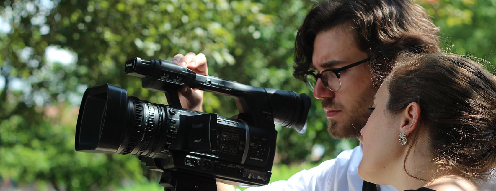 Two students looking through a video camera