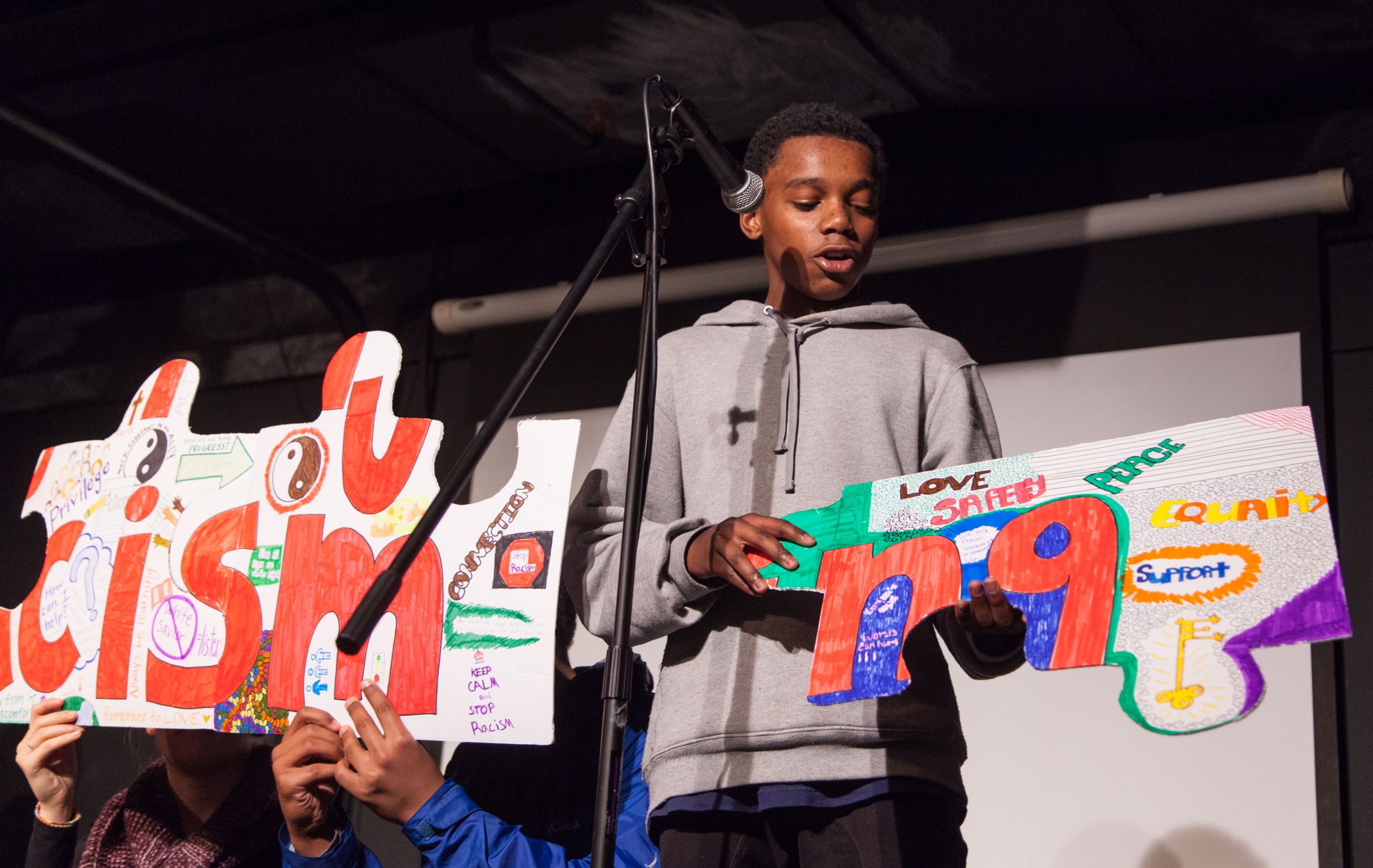 A group of PLU and Lincoln High School students present their hand-made puzzle project titled "Keep an Open Mind" in The Cave. (Photo by John Froschauer/PLU)