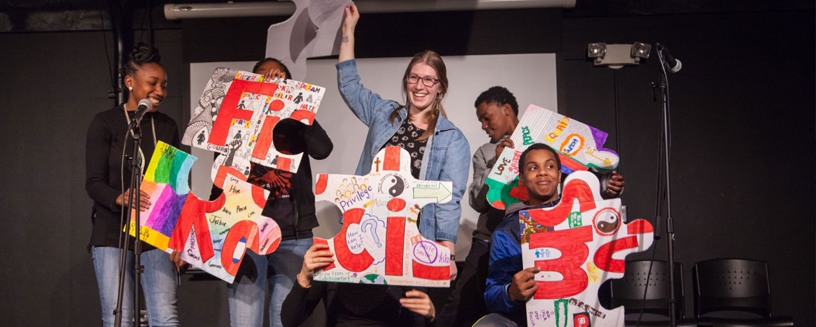 A group of PLU and Lincoln High School students present their hand-made puzzle project titled "Keep an Open Mind" in The Cave. (Photo by John Froschauer/PLU)