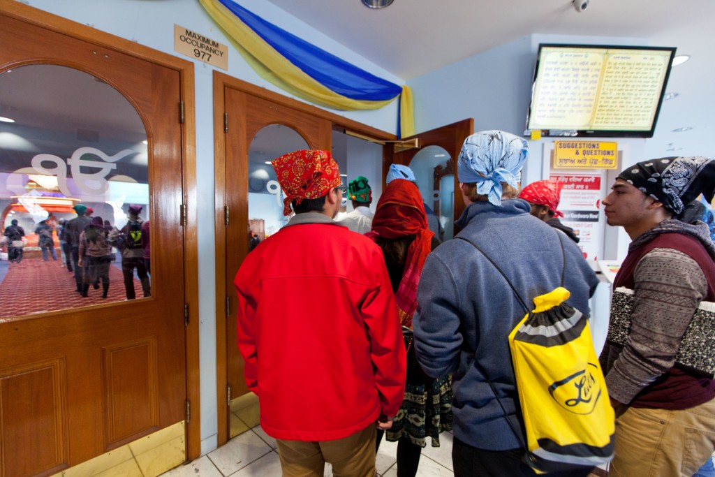 Students enter the main shrine space of the Gurudwara Singh Sabha, looking forward to hearing gurbani, the singing of the hymns of the Guru Granth Sahib