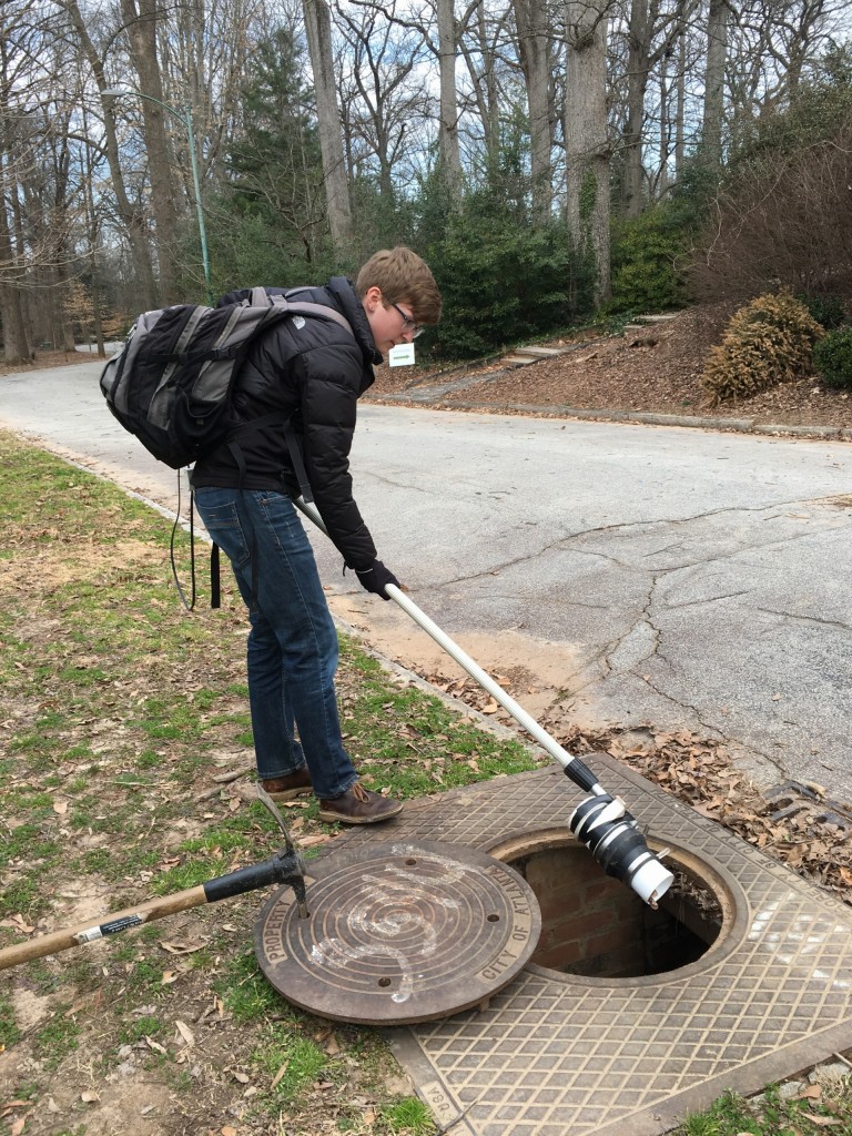 Rebekah Blakney '12 collects adult mosquitoes from catch basins in a local park to identify and test for West Nile Virus using an aspirator, a tool with a design patented by her boss Gonzalo Vazquez-Prokopec.