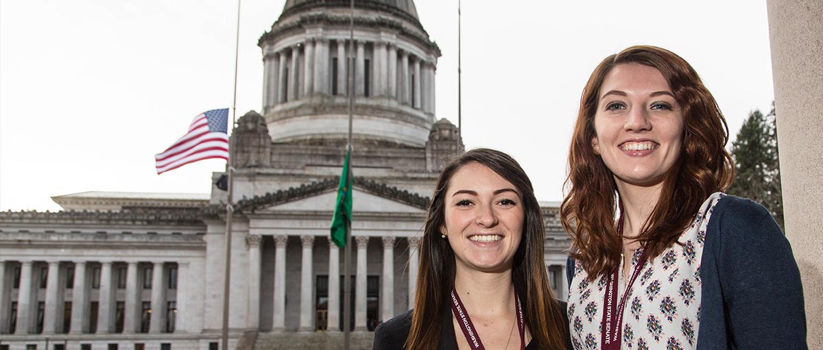 PLU students and legislative interns Savannah Turner '16 and Kacie Masten '17 outside the Washington State Capitol in Olympia. (Photo by John Froschauer/PLU)