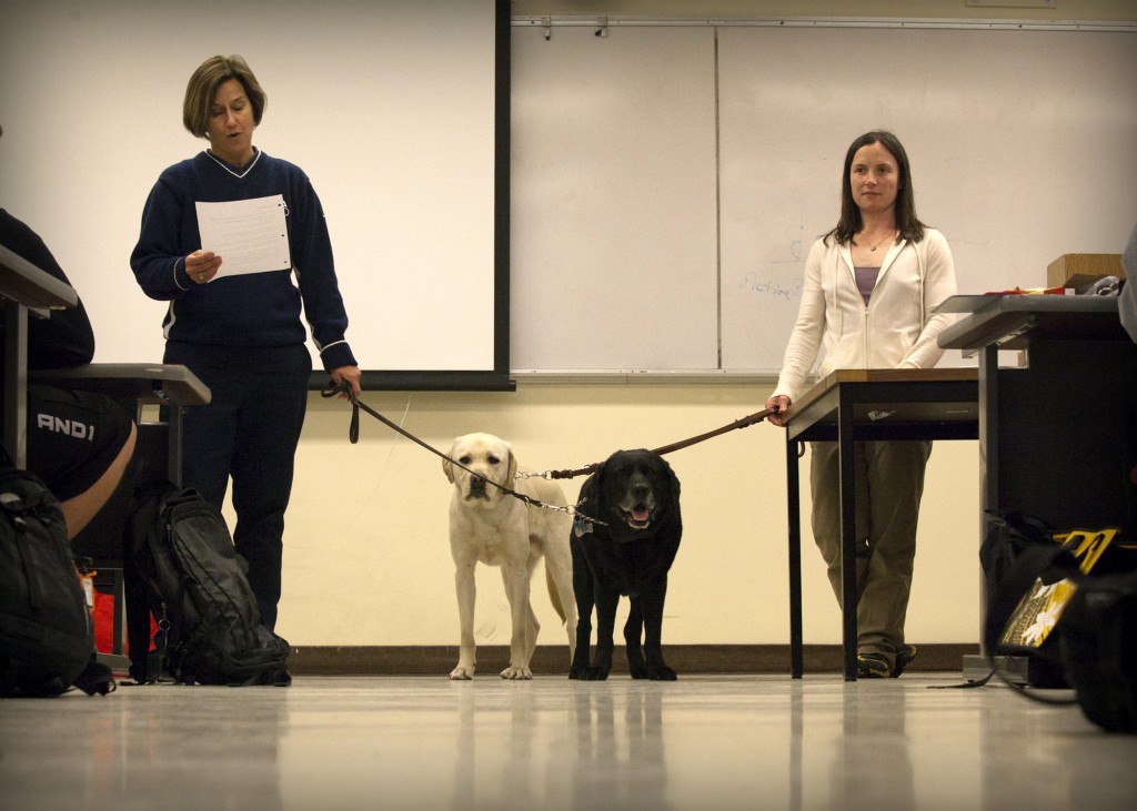 Natalie McCarthy, PLU alumna and bronze medalist in the 2013 World Rowing Championship, speaks to students in a class taught by Dr. Colleen Hacker (left) on March 15. (Photo: Robert R. Carrasco/PLU)