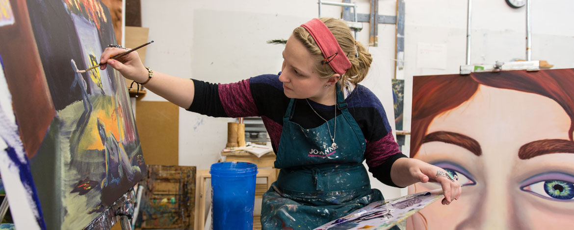 Emily White '17, paints one of two pieces she plans to submit to a student exhibition opening April 23 in the Scandinavian Cultural Center at Pacific Lutheran University. The work was inspired by Edvard Munch, a Norwegian artist who will be featured at Tacoma Art Museum through July 17. (Photo: John Froschauer/PLU)