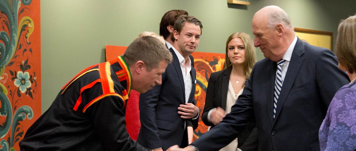 His Majesty King Harald V of Norway (left) is greeted by PLU Norwegian and Scandinavian studies professor Troy Storfjell in the Scandinavian Cultural Center on May 23, 2015.