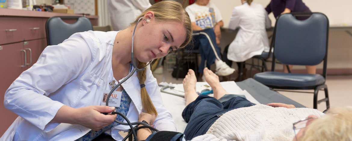 A PLU nursing student works with a patient at the Sumner Senior Center.