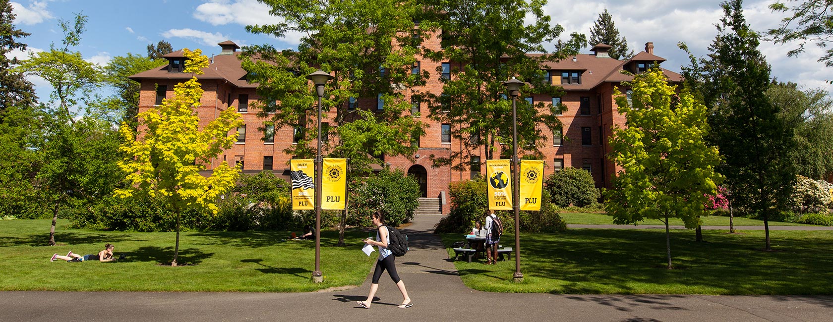 Harstad hall with students on a warm spring day at PLU