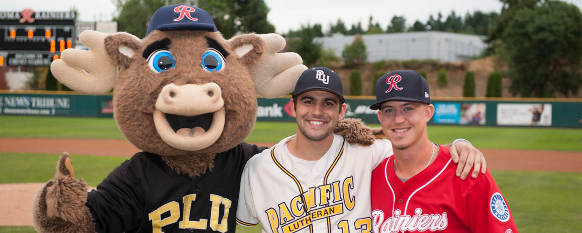 Rainiers mascot, Rhubarb the Reindeer, is seen with a PLU student and a member of the Tacoma Rainiers