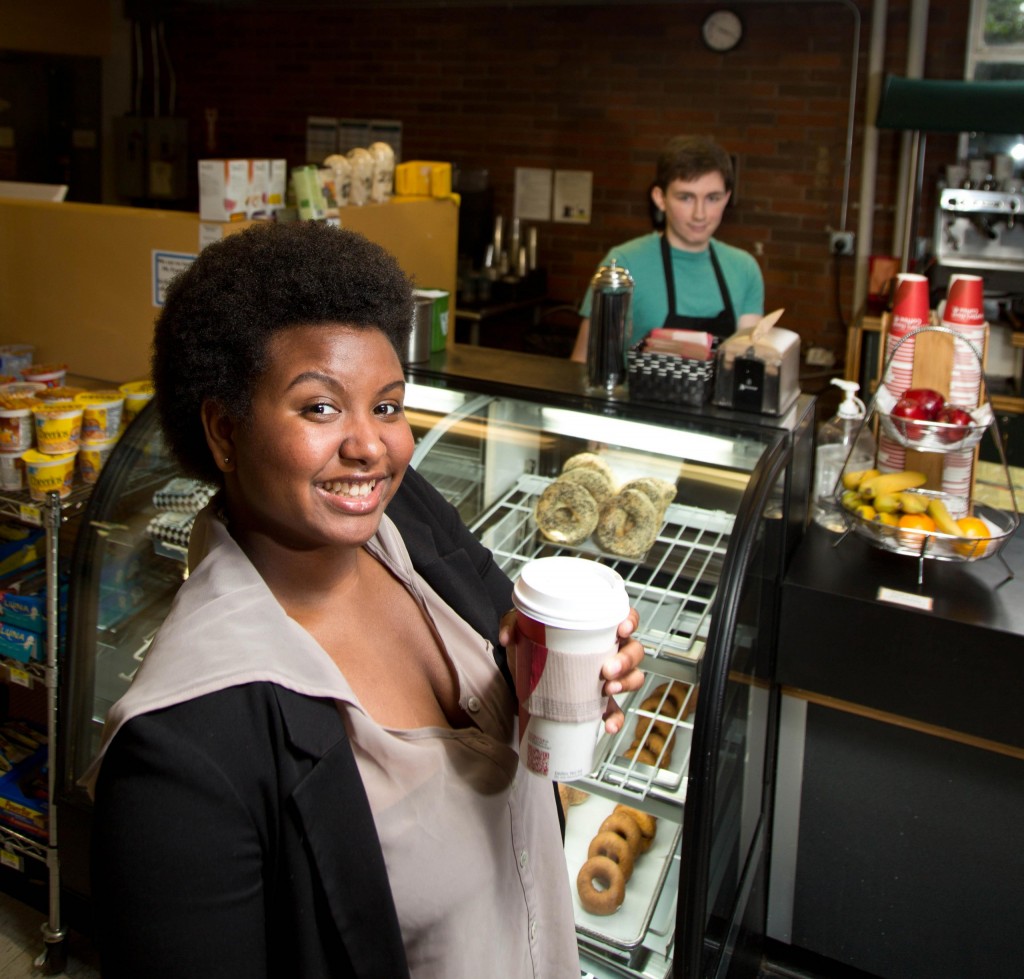Brooke Thames poses with a coffee at the Tahoma Cafe on campus at PLU.
