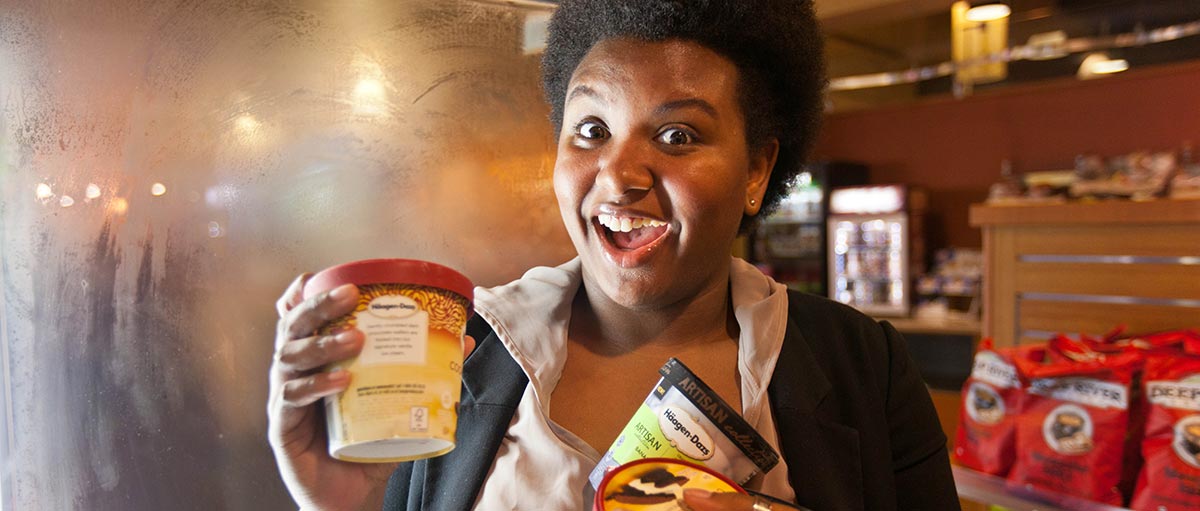 Brooke Thames holding multiple ice cream containers at PLU's Old Main Market