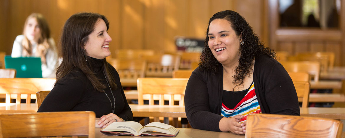 Janet Dela Cruz '16 sits in a classroom on PLU's campus earlier this year. (Photo by John Froschauer/PLU)