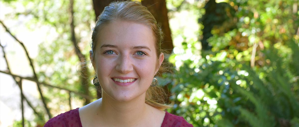 2016-17 ASPLU president Ellie Lapp smiling on PLU's upper campus.