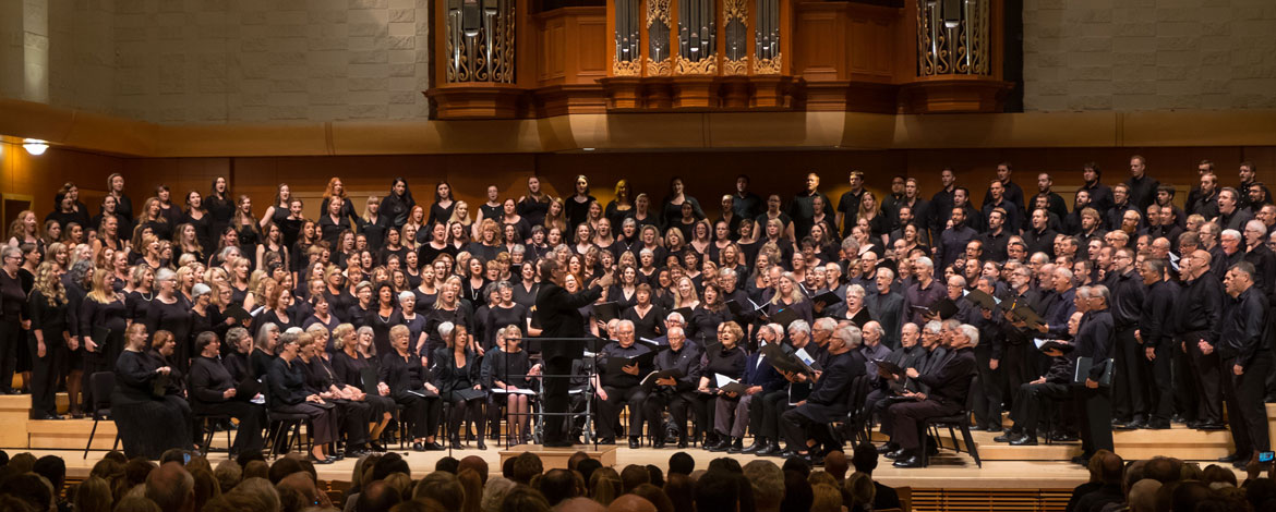 Choir of the West alumni from multiple generations gather onstage in Lagerquist Concert Hall during Homecoming weekend as part of their 90th anniversary celebration. (Photo by John Froschauer/PLU)