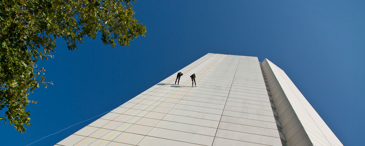 President Tom Krise and his wife, Patty, rappel down the Hotel Murano in downtown Tacoma on Friday, Sept. 30, as part of a Habitat for Humanity fundraiser. (Photo by John Froschauer/PLU)