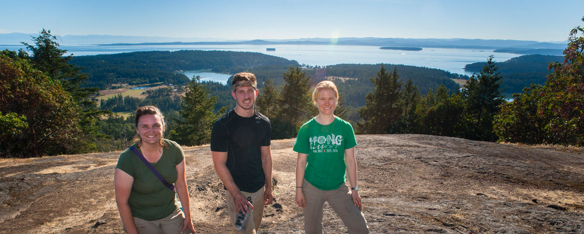 Emma Holm '17, Grant Schroeder '17, Georgia Abrams '18 (right to left) on Mount Young on San Juan Island during their summer dig in Roche Harbor. (Photo by Theodore Charles '12)