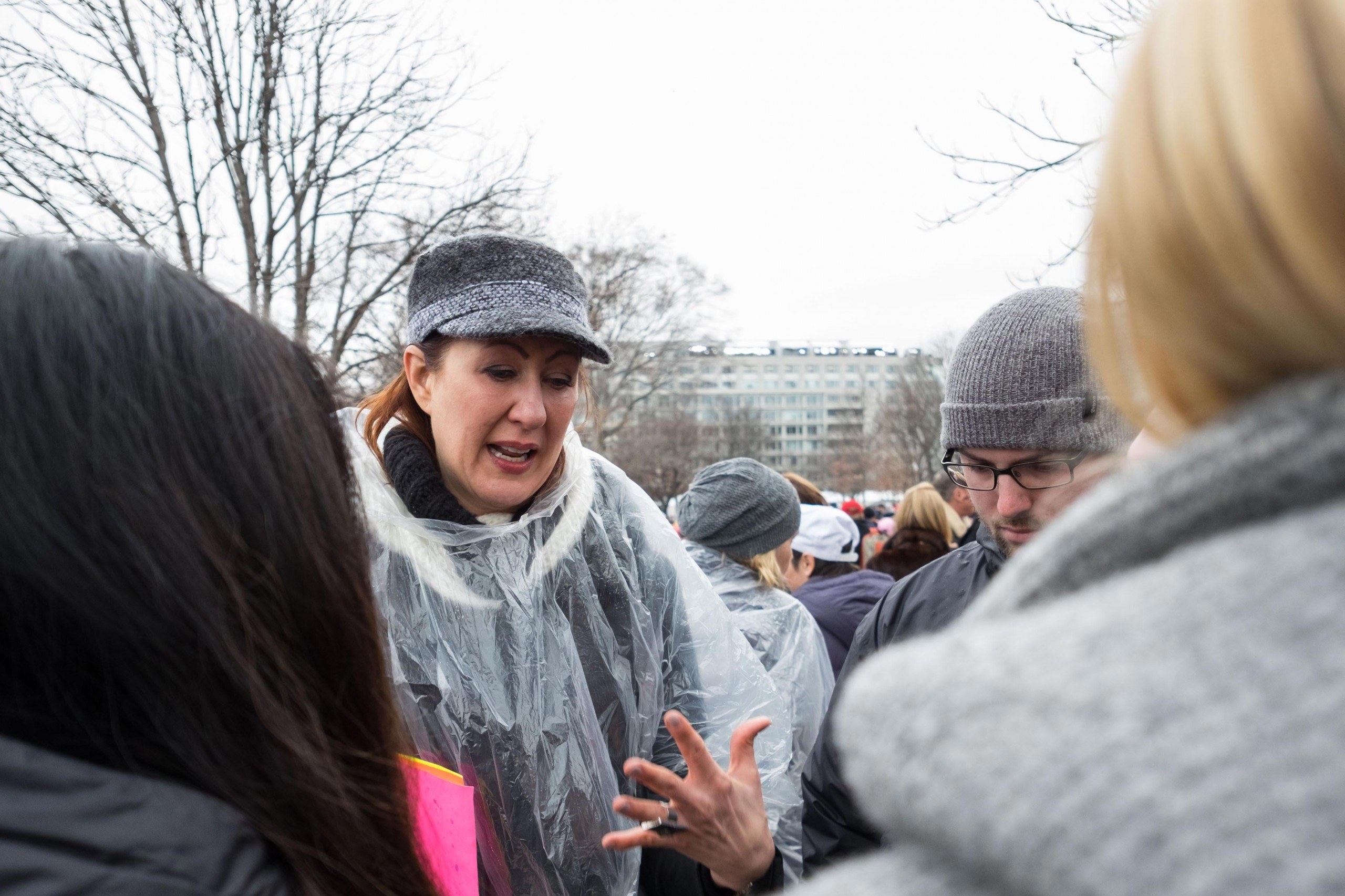 A protestor at inauguration talks to PLU students.