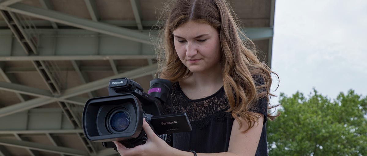 MediaLab General Manager Rachel Lovrovich '18 shoots on location at the Ohio River. (Photo courtesy of MediaLab)