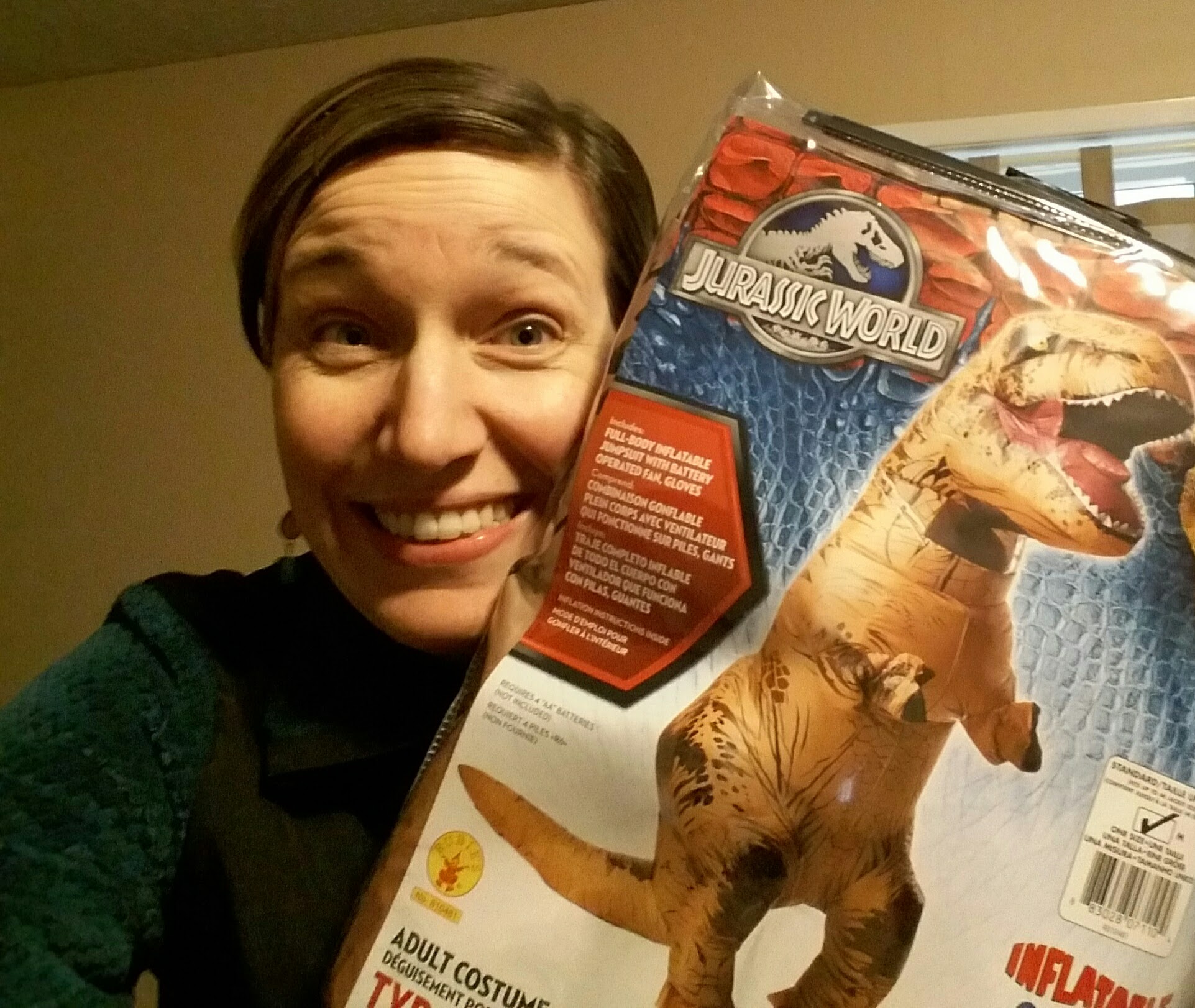 Sarah (Allen) Caprye ’01 holding the T-rex costume for the first time, just before she transformed into Spokanasaurus Rex. (Photo courtesy of Caprye)