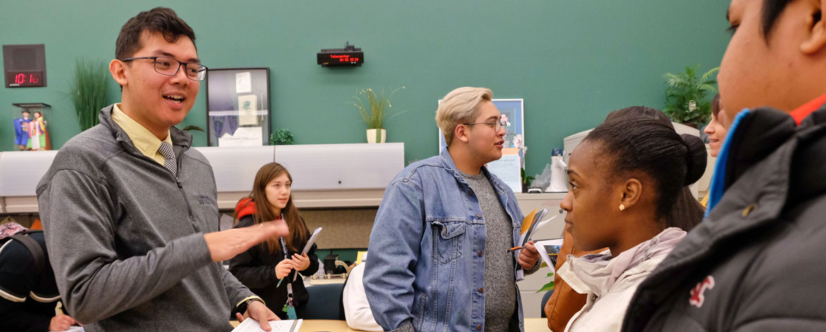 Julian Franco presents information to local students about Pacific Lutheran University's 253 PLU Bound scholarship program at Todd Beamer High School in Federal Way in December 2015. (Photo by John Froschauer/PLU)