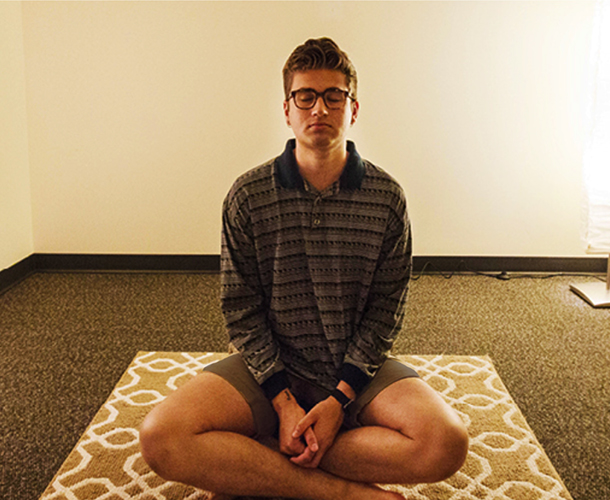 Matthew Salzano '18 meditates in the new Multifaith Meditation and Prayer Space. (Photo by John Froschauer/PLU)