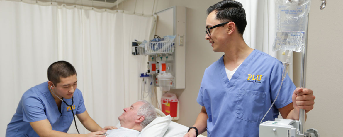 Nursing students Derek Quan and Jed Gosnell in the PLU nursing lab on Wednesday, Feb. 17, 2016. (Photo: John Froschauer/PLU)