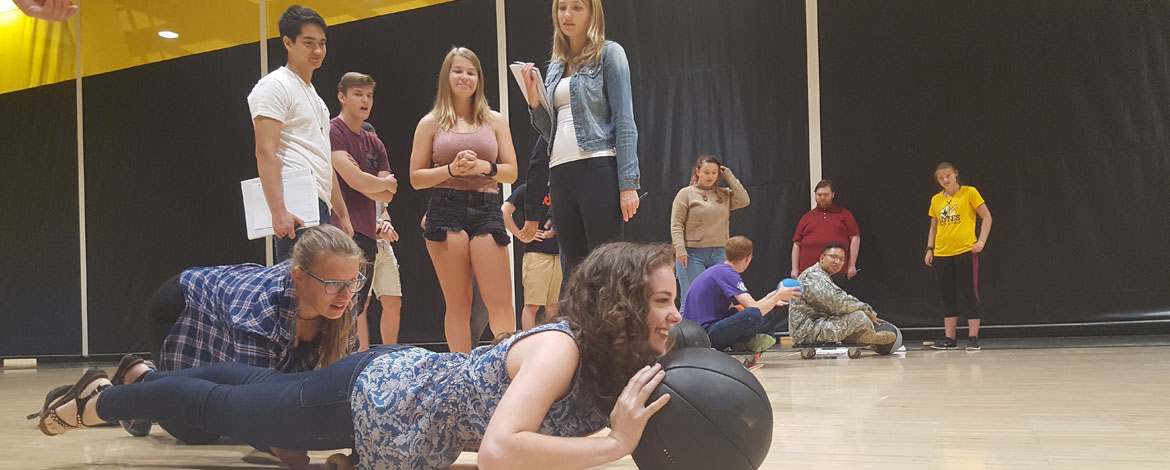 Students in Daniel Heath's course titled "How to Build a Starship" conduct an experiment involving skateboards and medicine balls to demonstrate how spacecraft propulsion works. (Photo by Kari Plog/PLU)