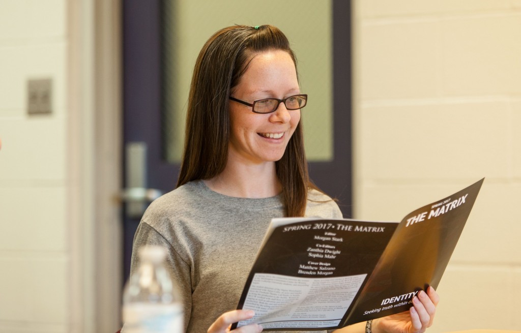 WCI-4-21-17-550 Samantha, an inmate at Washington Corrections Center for Women, reads a copy of The Matrix during a meeting with PLU students on Friday, April 21, 2017. (Photo by John Froschauer)