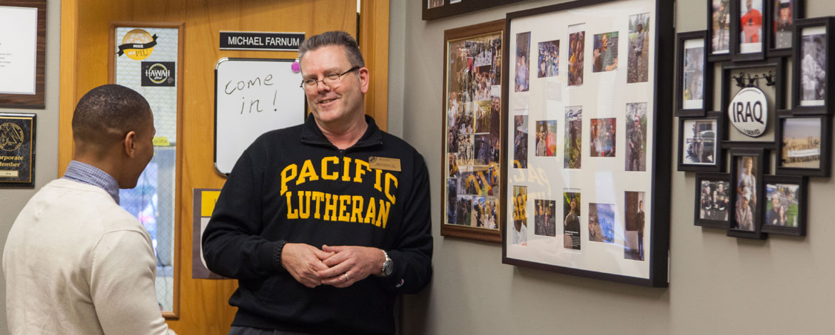 Michael Farnum, director of military outreach, talks with an ROTC cadet in the Center for Military Support at PLU. (Photo by John Froschauer/PLU)