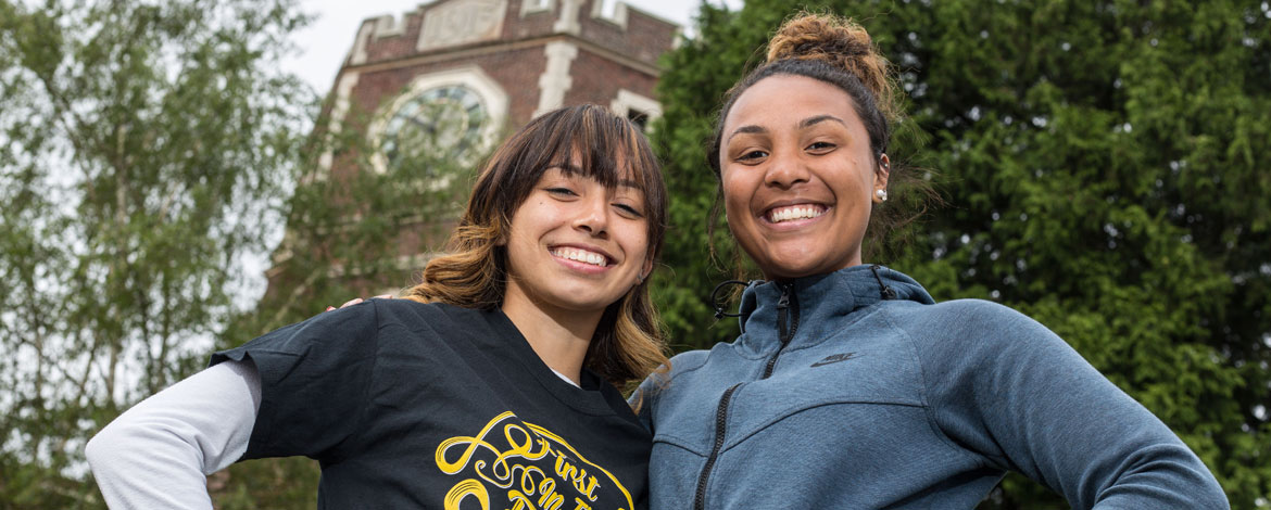 Kaeki-Lawni Proctor (right) and Itzelly Rubio ’22 outside their alma mater, Lincoln High School, where they enrolled in Teach 253. Rubio will start classes at PLU in the fall, and Proctor will attend Oregon State. (Photo by John Froschauer/PLU)