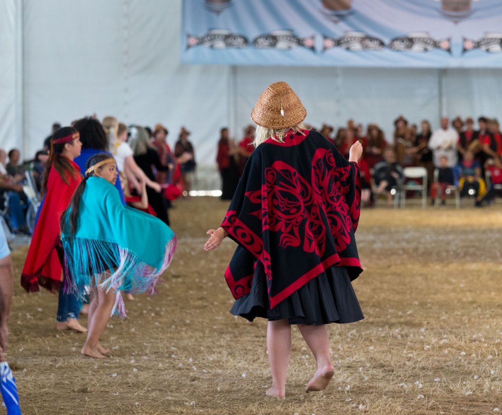 paddle-puyallup-8-3-18-4071 Samish tribal members dance during protocol, a ceremonial sharing of stories, songs and dances during the Power Paddle to Puyallup, this year's annual tribal canoe journey hosted by the Puyallup Tribe of Indians. (Photo by John Froschauer/PLU)