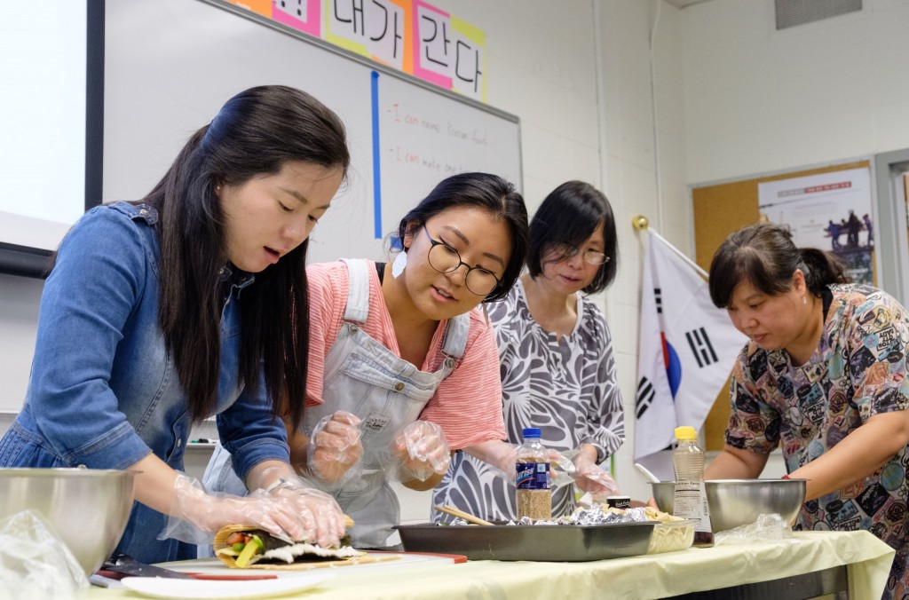 startalk-8-10-18-1711 Hanna Park '20, second from left, helps with a STARTALK teacher's lesson plan on Aug. 10. The class learned — all in Korean — how to make kimbap, a sort of Korean sushi roll. (Photo by John Froschauer/PLU)