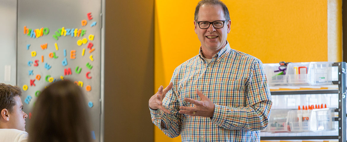 Michael Halvorson, Pacific Lutheran University's Director of Innovation Studies, talks with students in the Makerspace -- a a dedicated area in Hinderlie Hall for student creativity and collaboration.