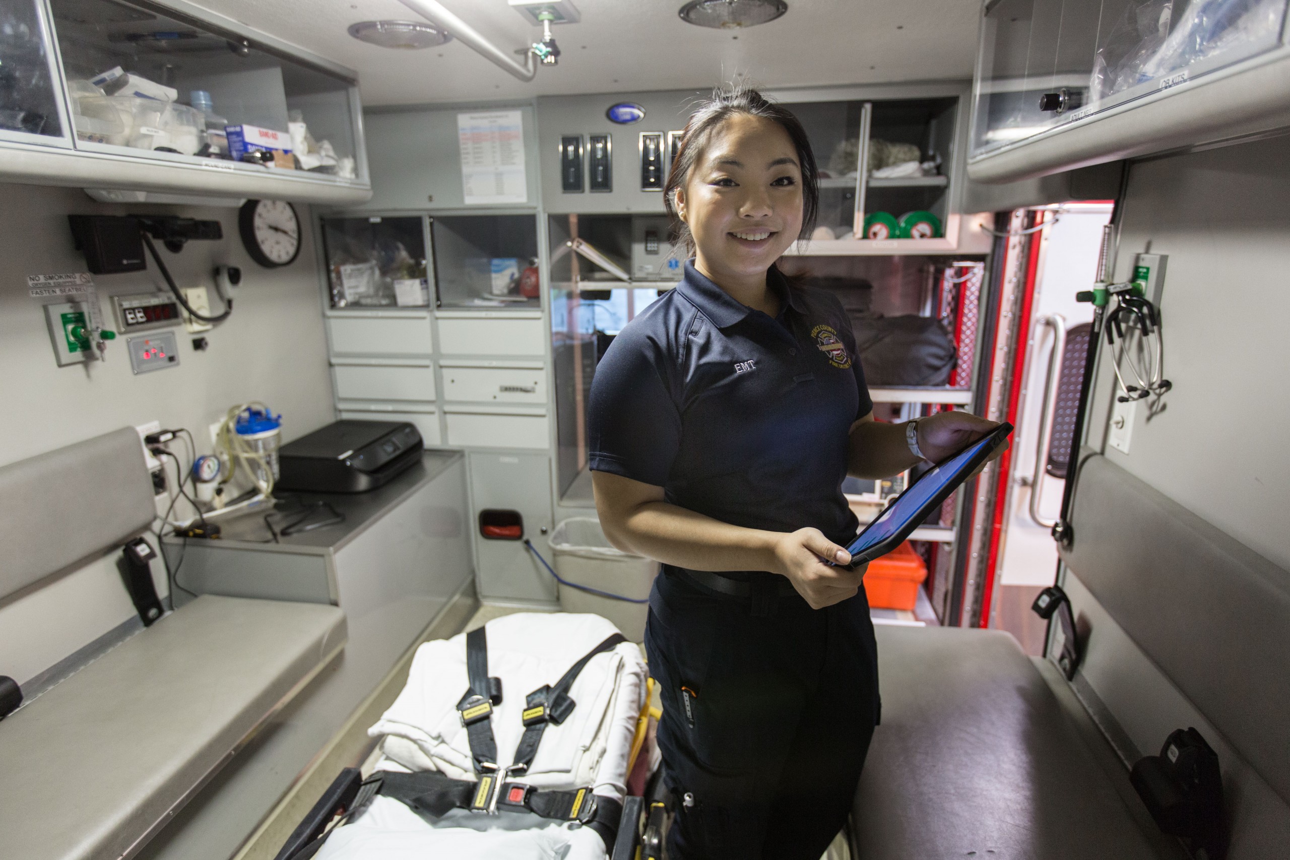 Sunny Huang '18, checking the medic unit before her volunteer shift as an EMT at the Brown's Point station of the Pierce County Fire Dept., Thursday, March 22, 2018. (Photo: John Froschauer/PLU)