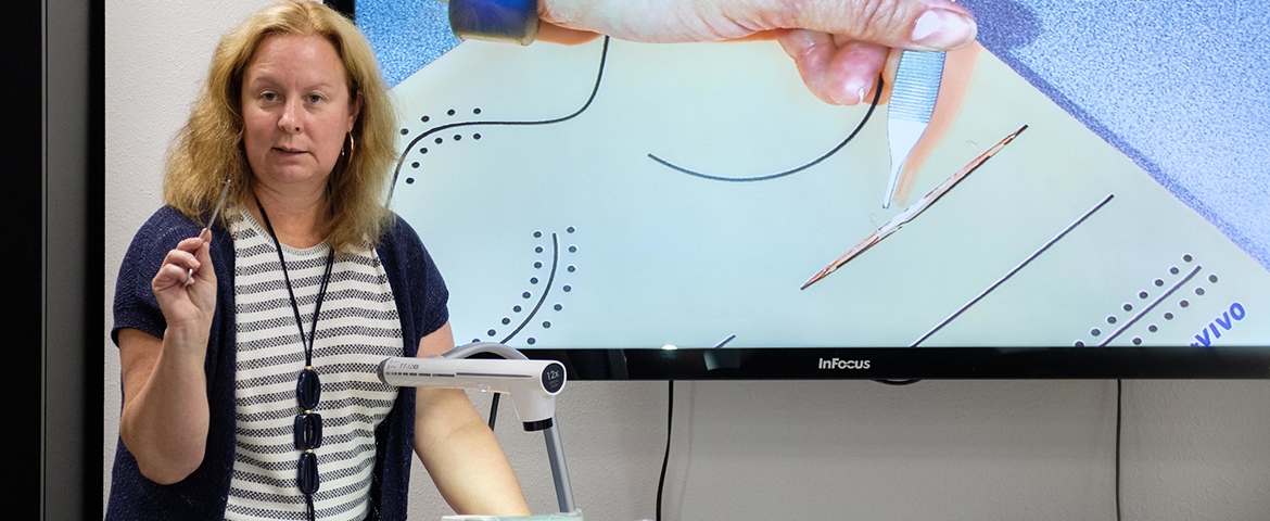 Graduate Program Coordinator and Assistant Professor of Nursing Kathy Richardson instructs a PLU nursing class on suturing.