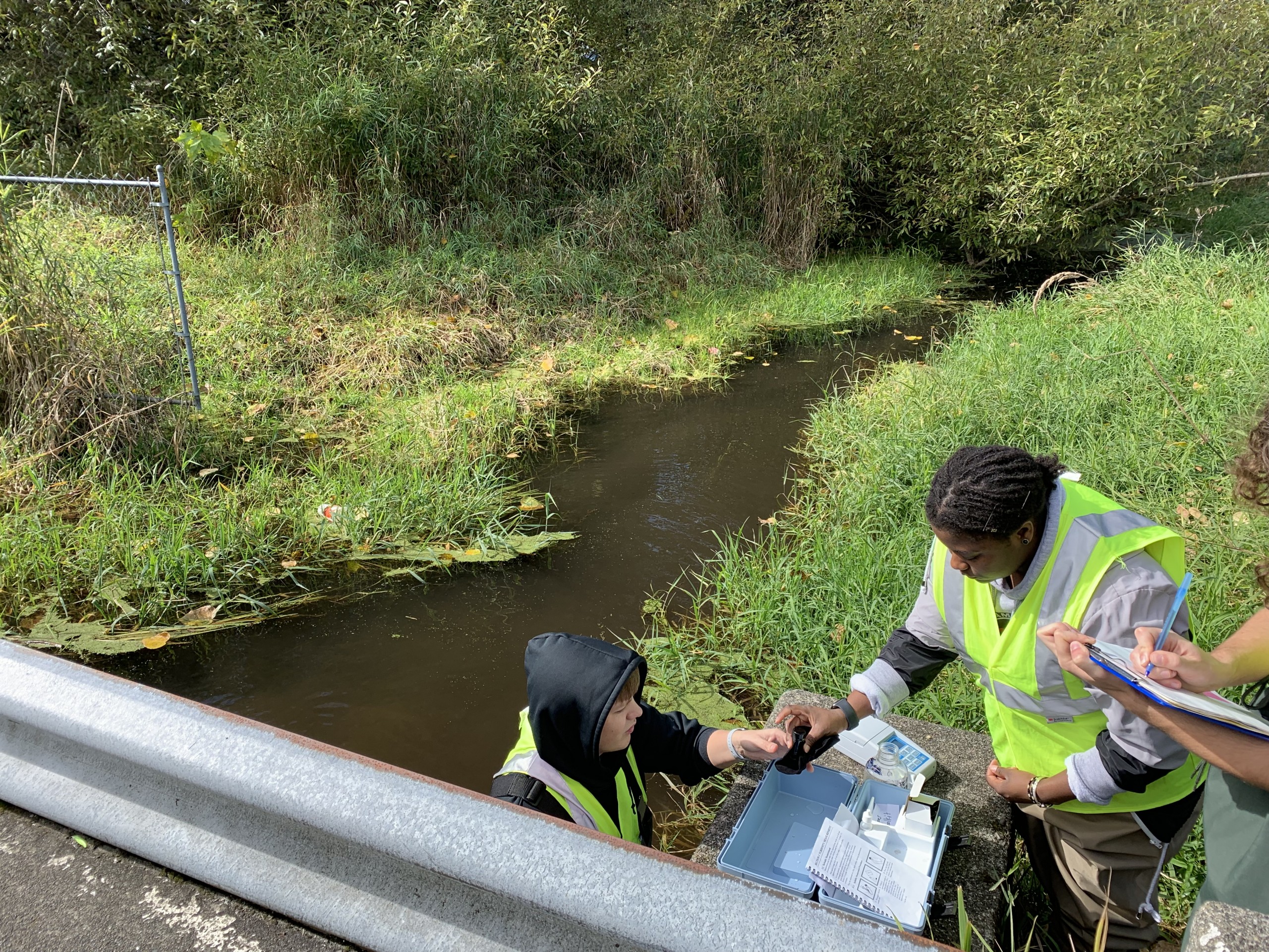 Photos of PLU students collecting samples near a stream bed.